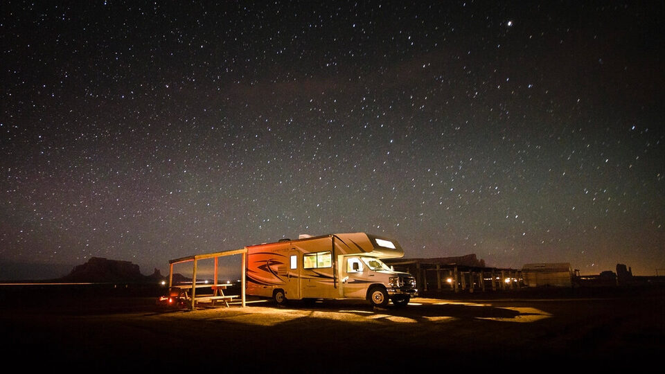 A camper glowing at a desert campsite at night