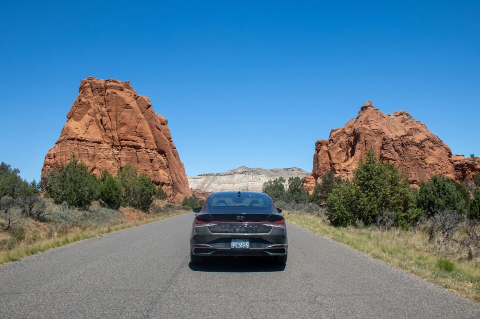 A car on an open road, seen from behind