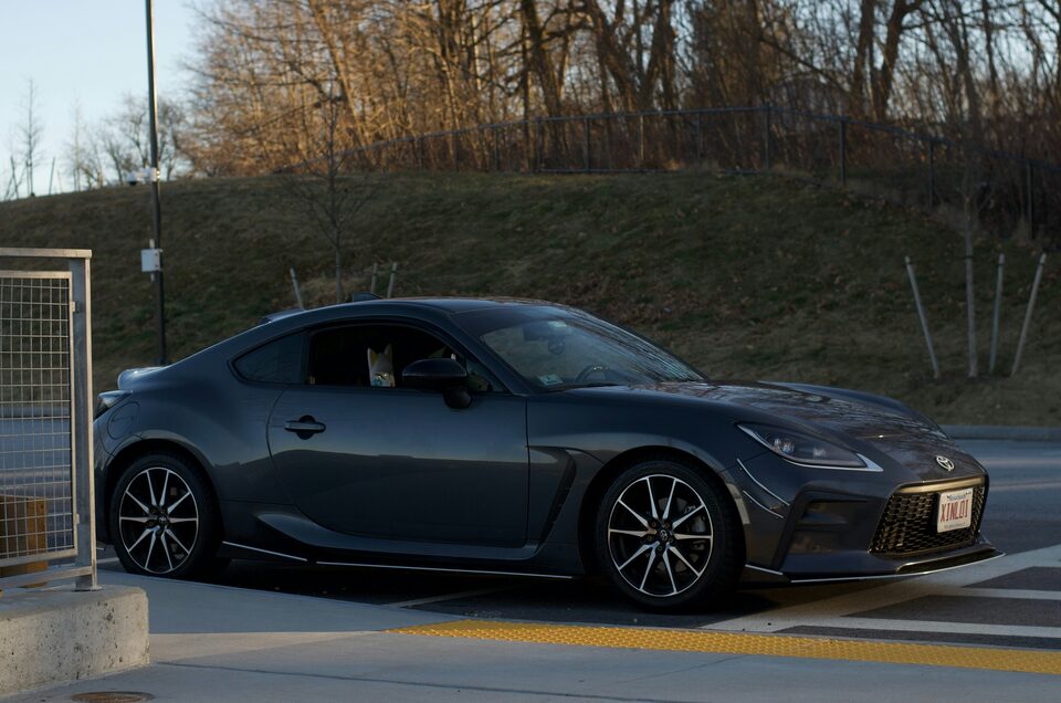 A charcoal sports coupe parked at dusk