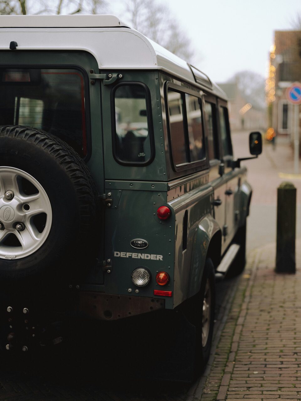 A green Land Rover from behind