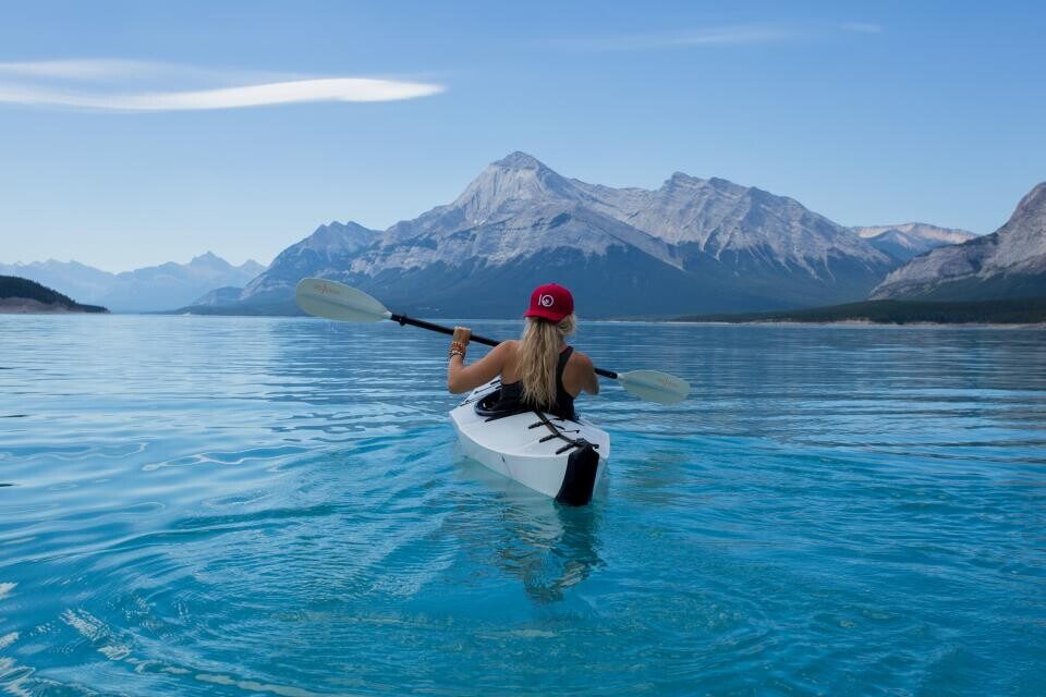 A kayaker on a mountain lake