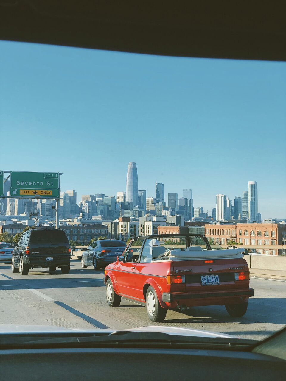 A truck driving away down a city street