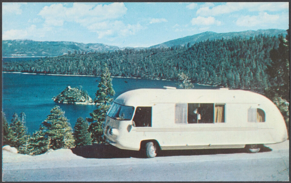 A retro motorhome parked by a lake