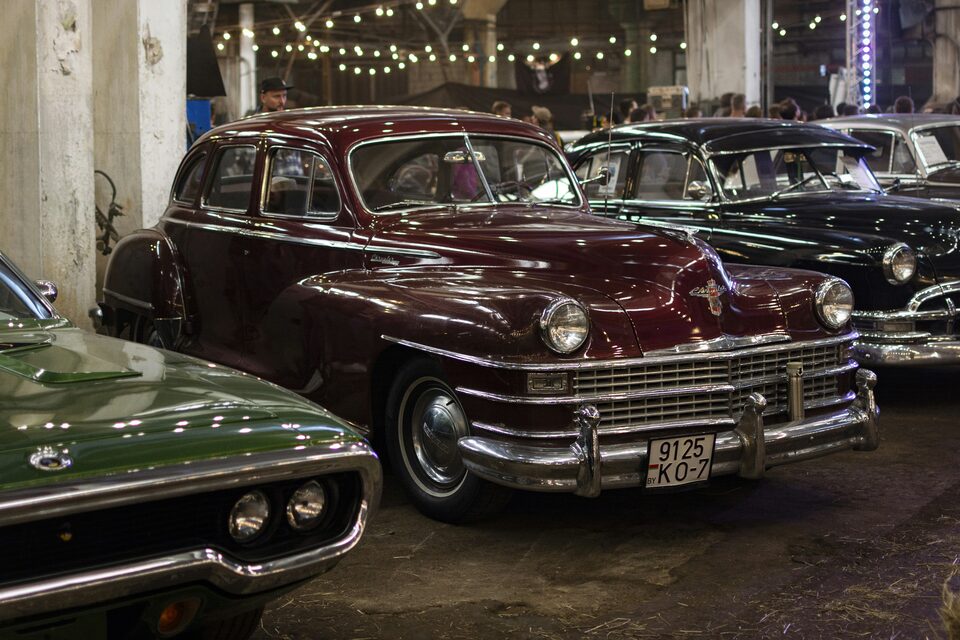 Cars lined up on an indoor dealership floor