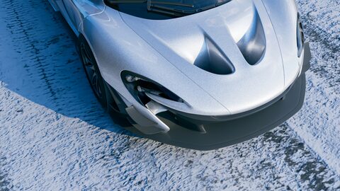 A silver McLaren supercar seen from above