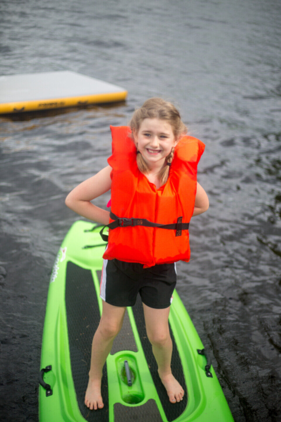 A smiling child in a life jacket