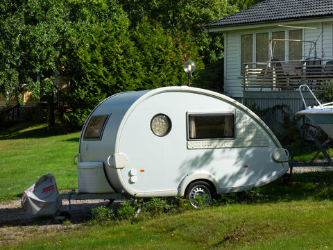 A teardrop trailer on a green lawn