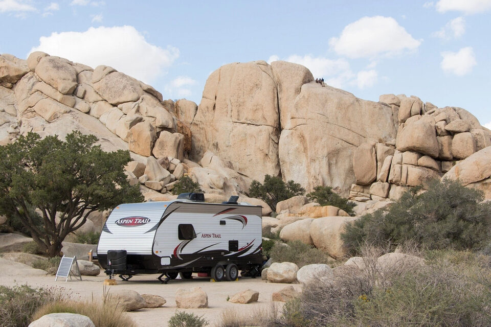 A travel trailer among desert boulders