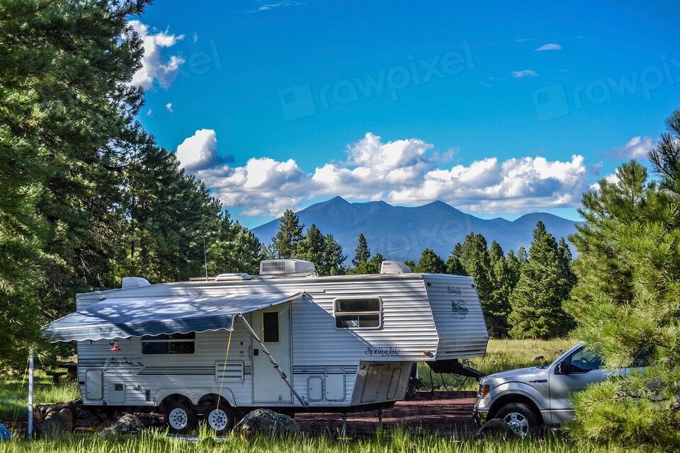 A travel trailer camped below the mountains