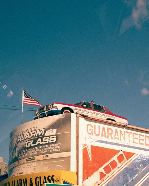 A truck with an American flag mounted above it