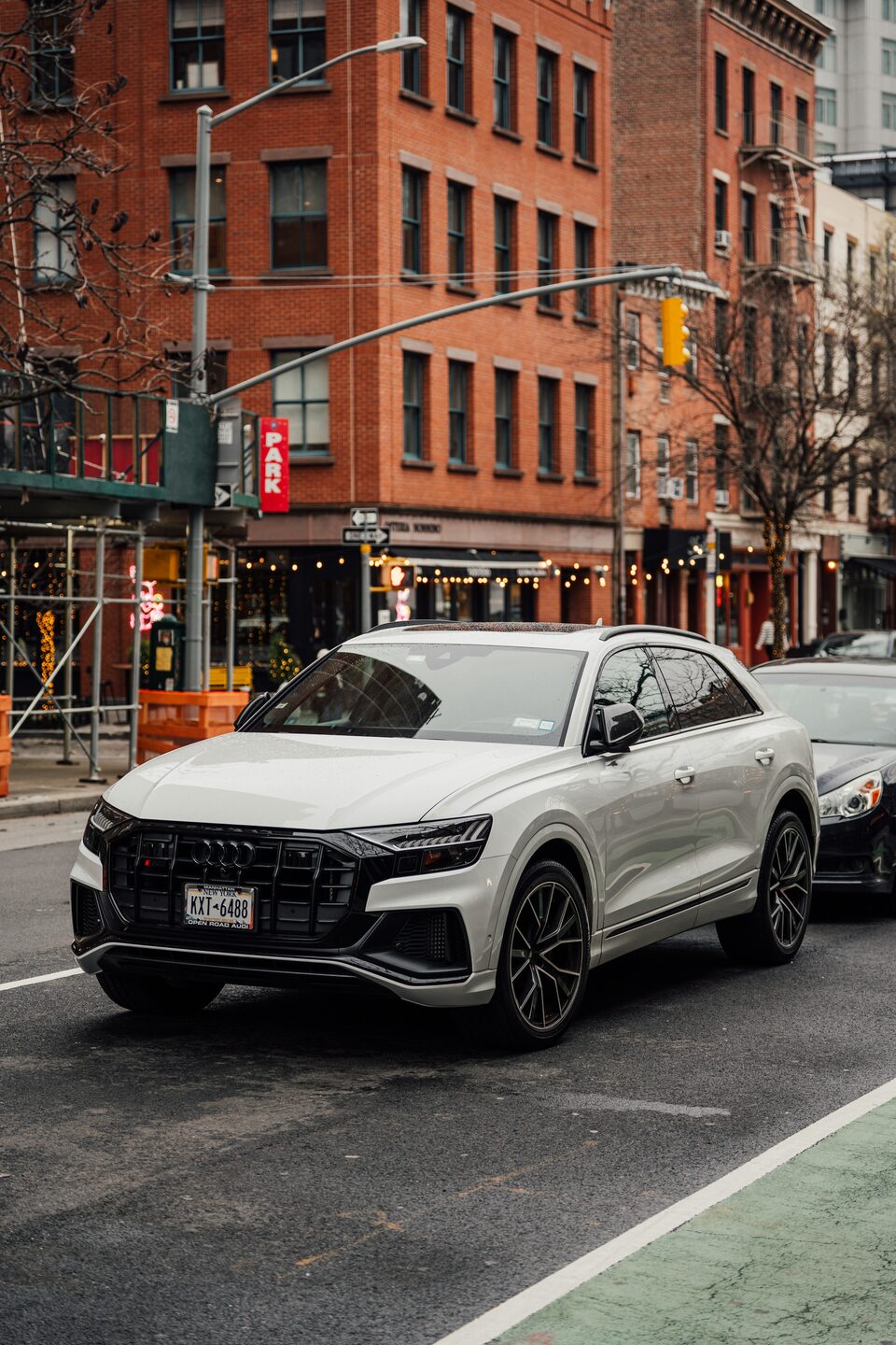 A white SUV parked on a city street