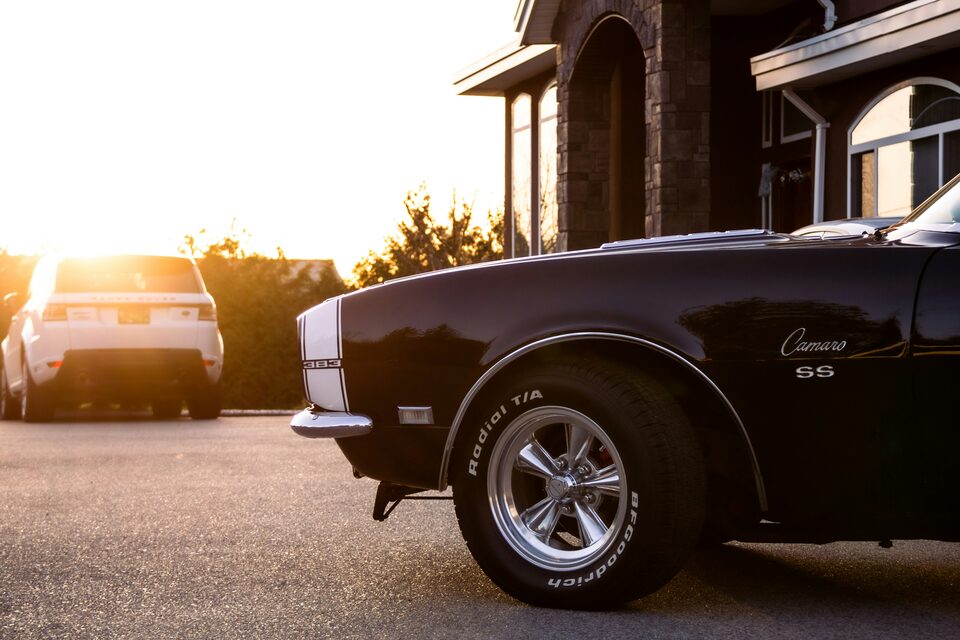 A black classic Camaro in low evening sun