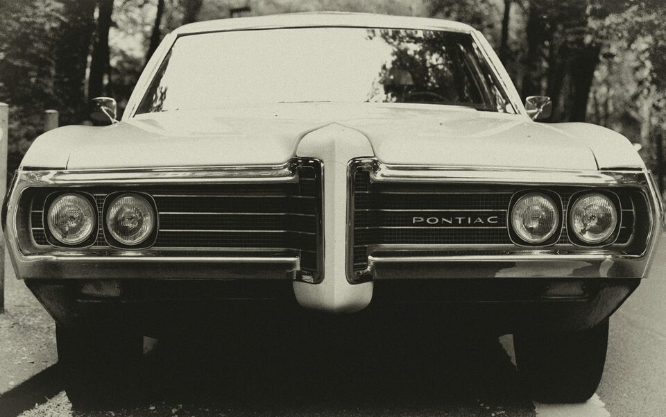 The front of a cream classic Pontiac