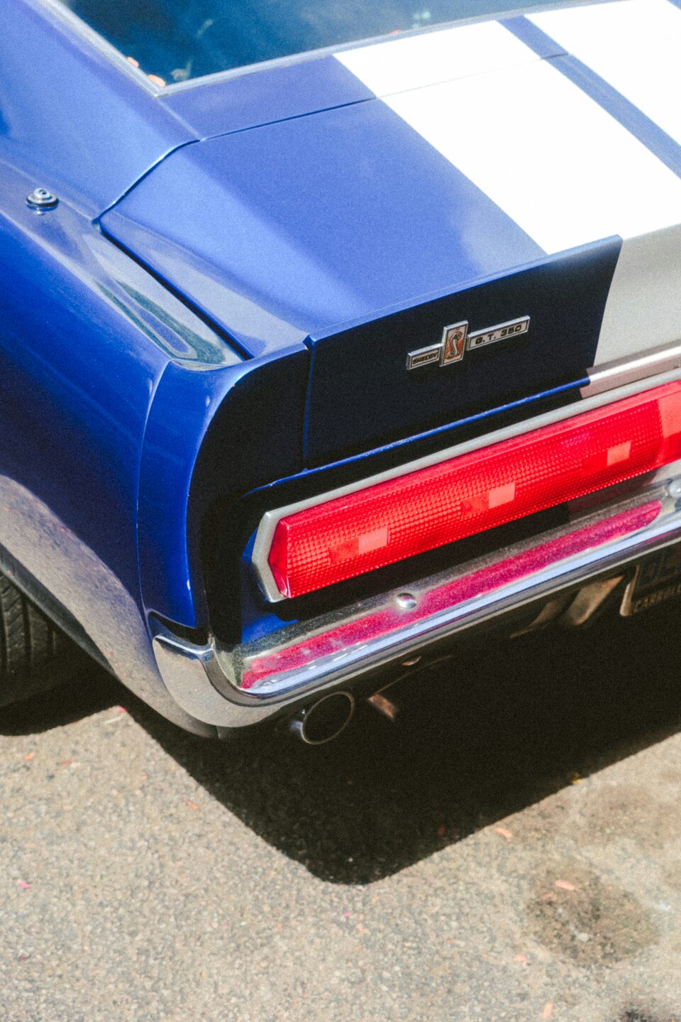 The taillight of a blue Ford Mustang