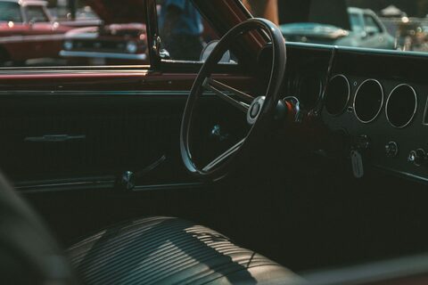 The dashboard and steering wheel of a classic car