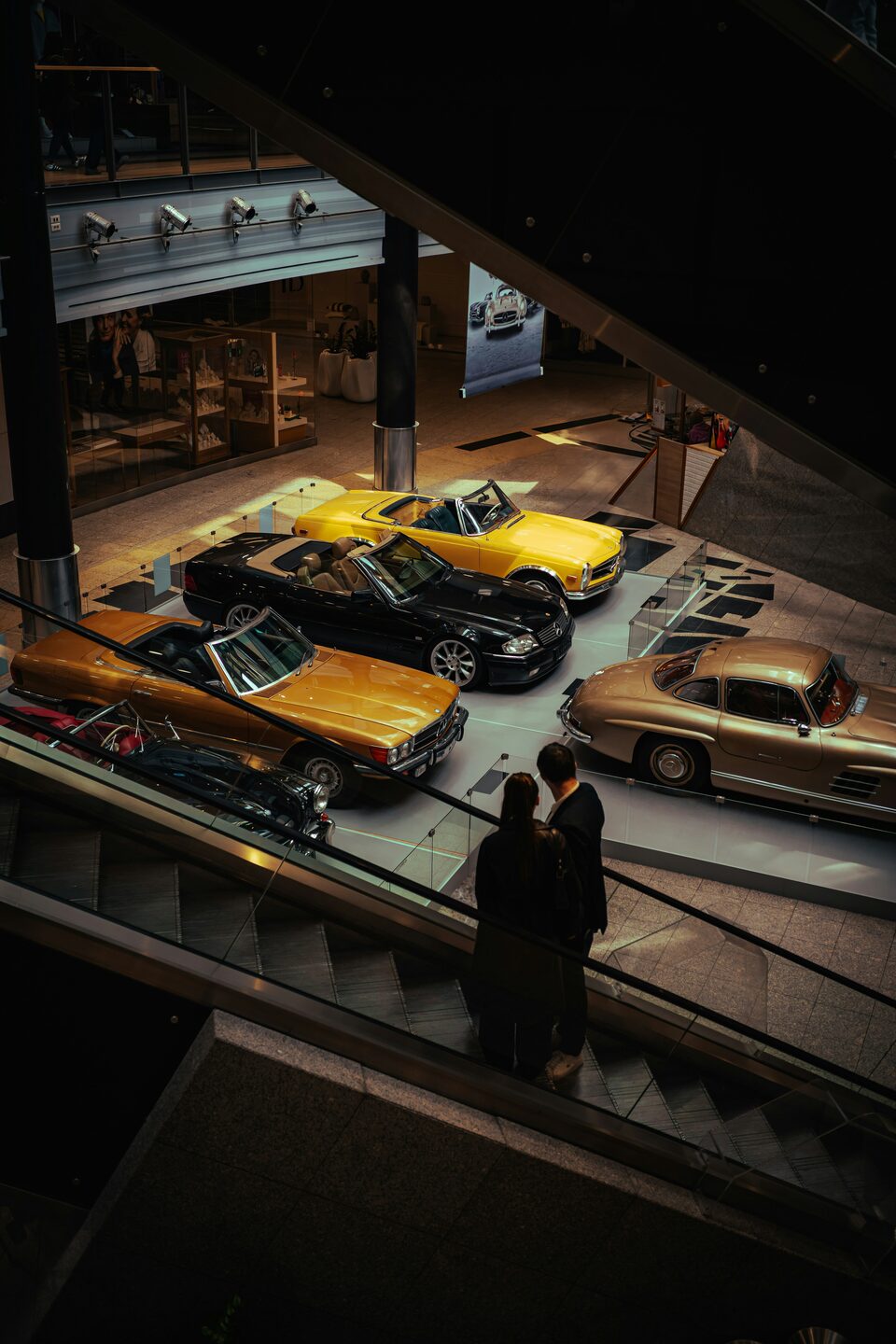 Classic sports cars displayed on a showroom floor