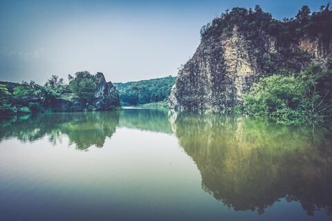 Cliffs and trees reflected in a still lake