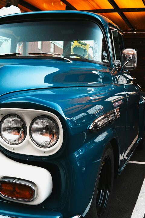 The blue front and twin headlights of a classic truck