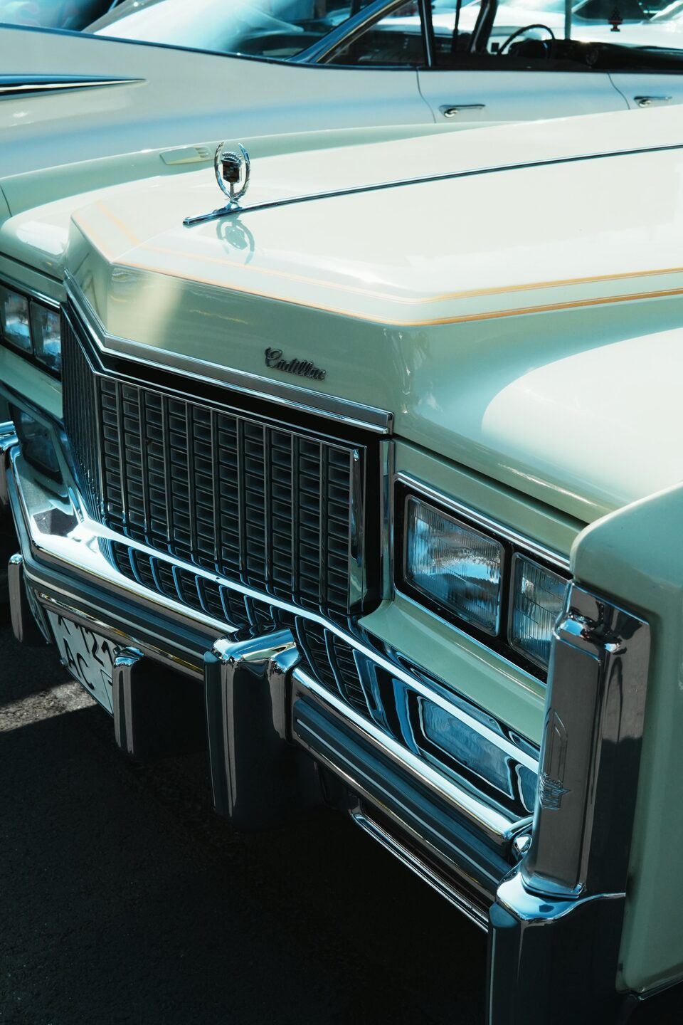 The grille of a mint green classic Cadillac