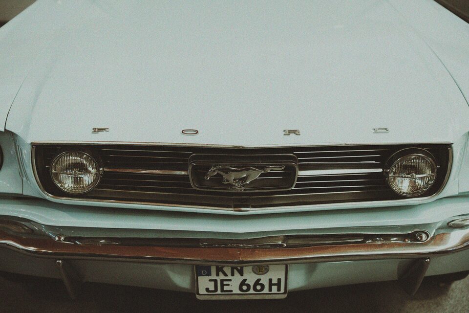The front of a mint green classic Ford Mustang