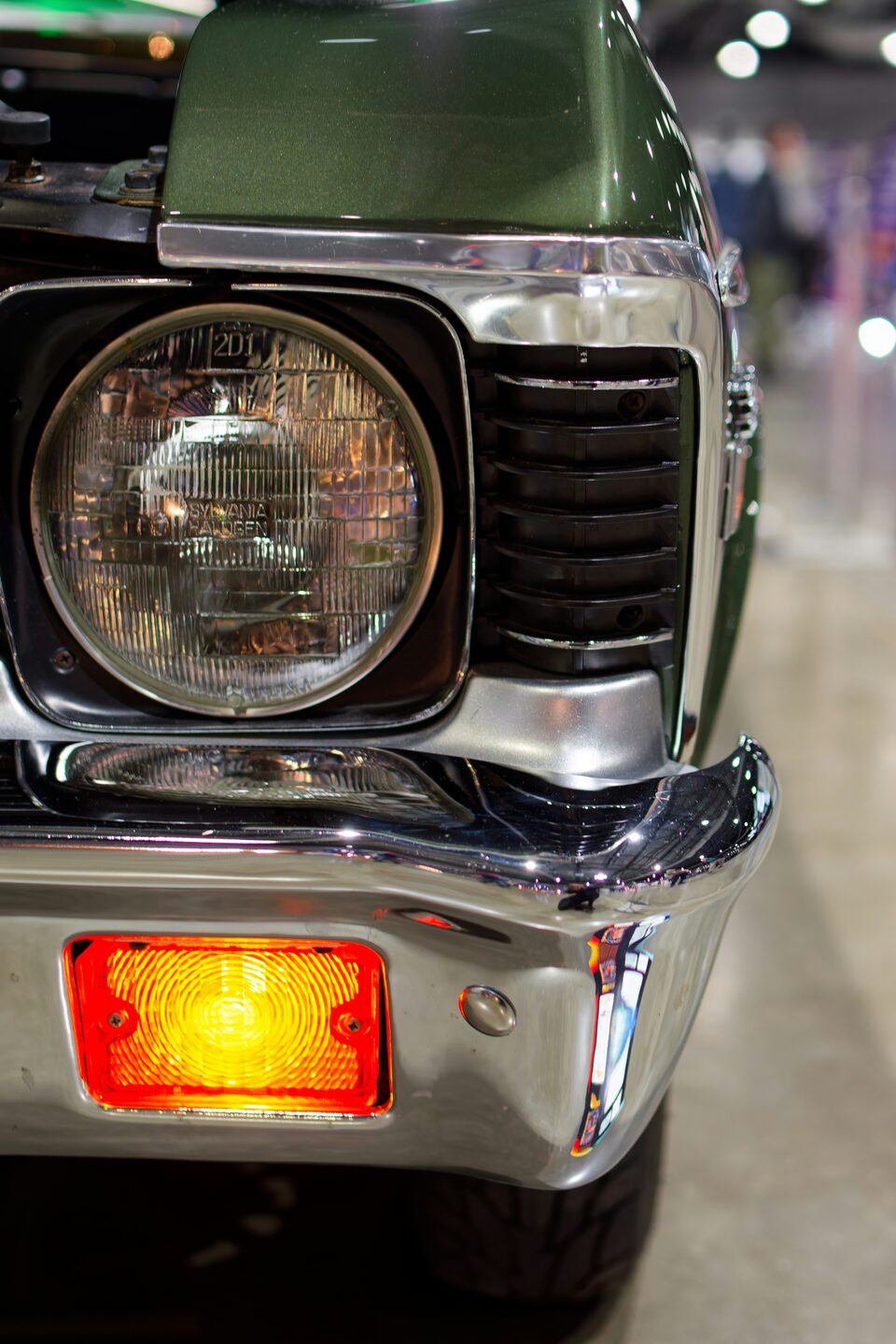 The round headlight of a classic car up close