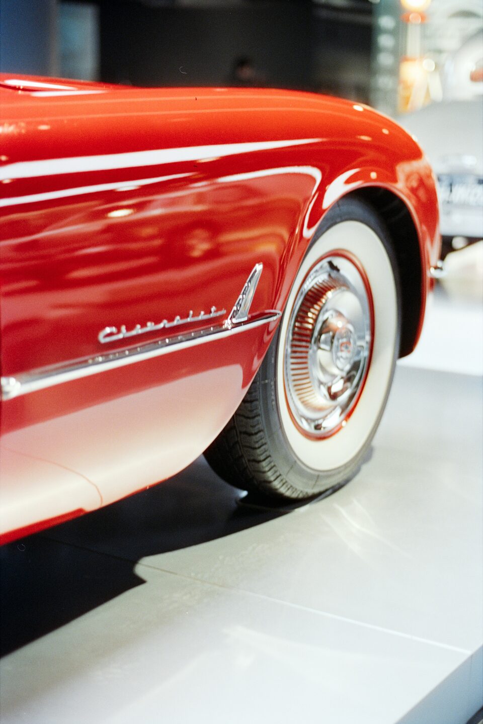 The whitewall wheel of a red classic Chevrolet