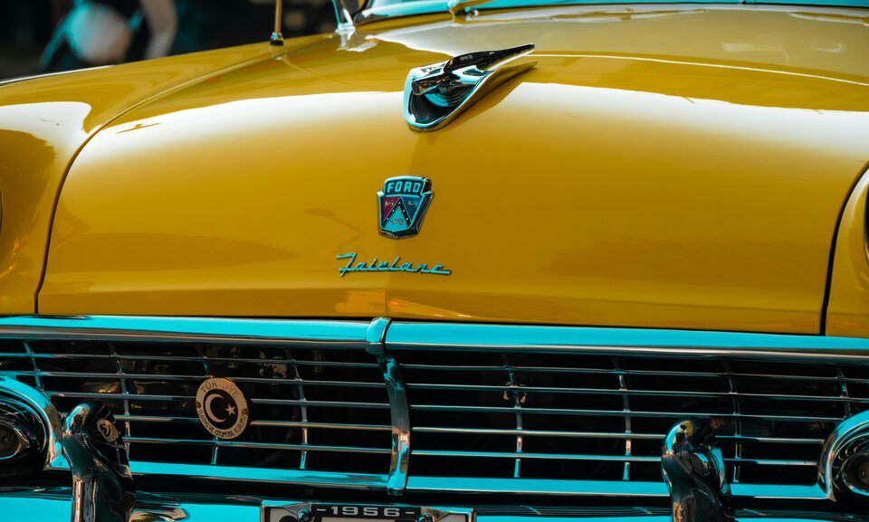 The gold hood and teal grille of a classic Pontiac