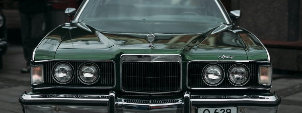 The grille of a dark green classic Mercury