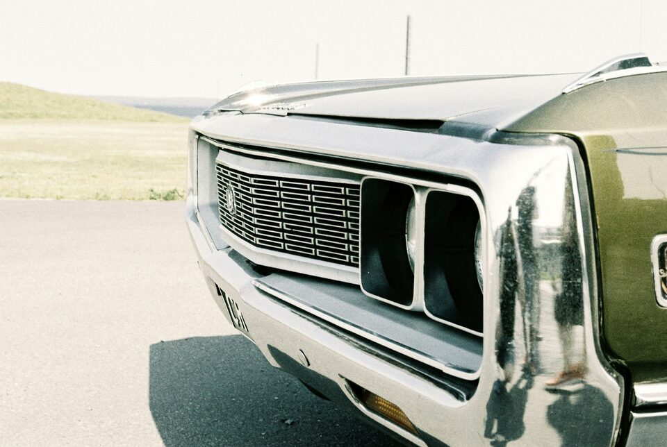 The chrome grille of a classic car in soft light
