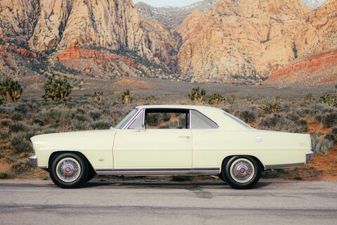 A cream classic coupe in red rock desert