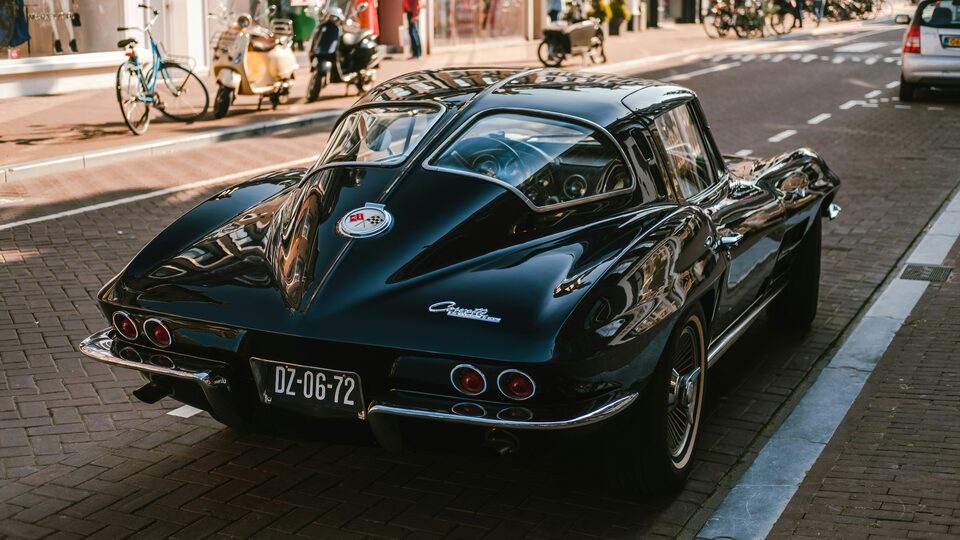 A black classic Corvette Stingray on a city street