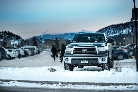 A white SUV parked on a winter lot