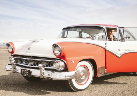 A red and white classic Ford Fairlane in the sun