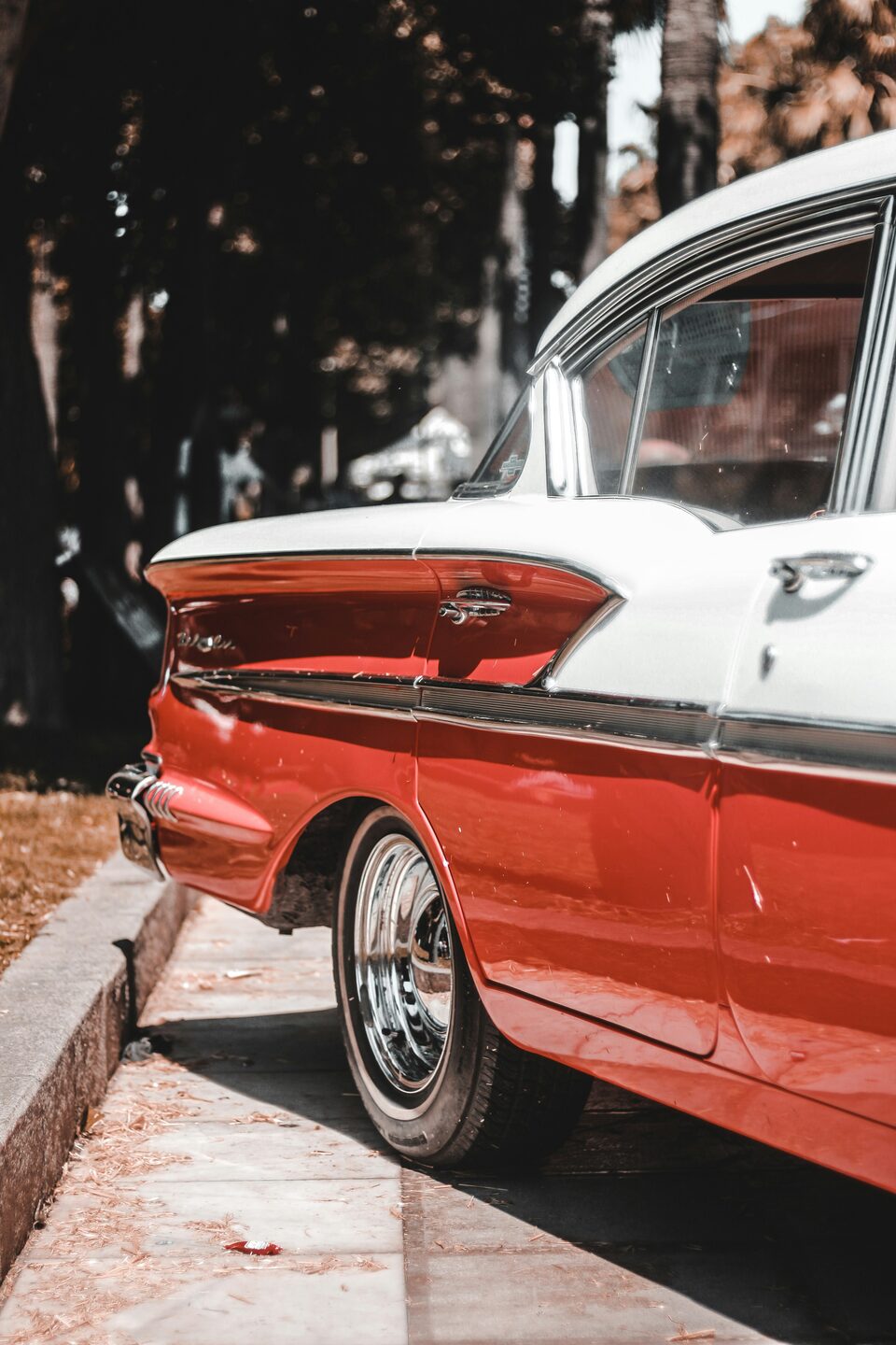 The fins of a red and white classic car