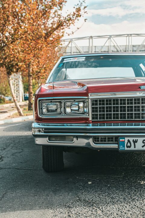 The chrome grille of a red and white classic Chevrolet