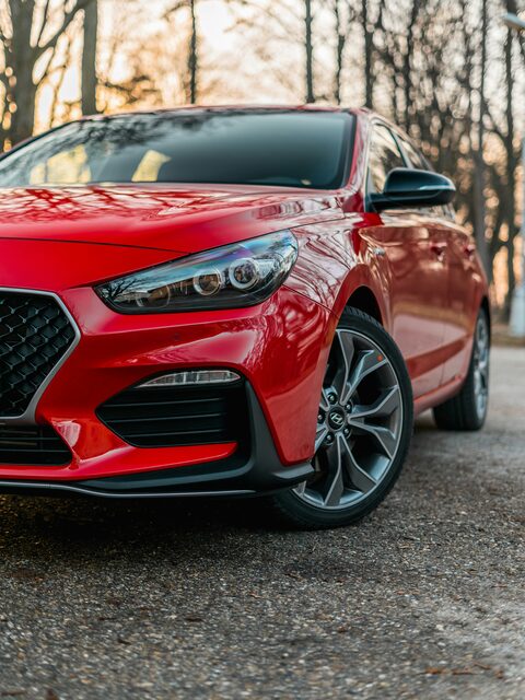 A red hatchback with sport wheels