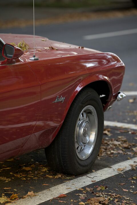 The red fender and wheel of a classic car