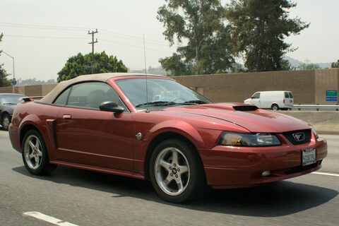 A red Ford Mustang convertible