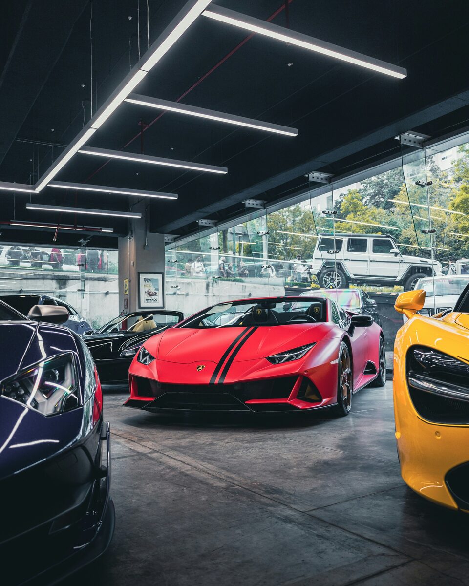 A red Lamborghini inside a glass showroom