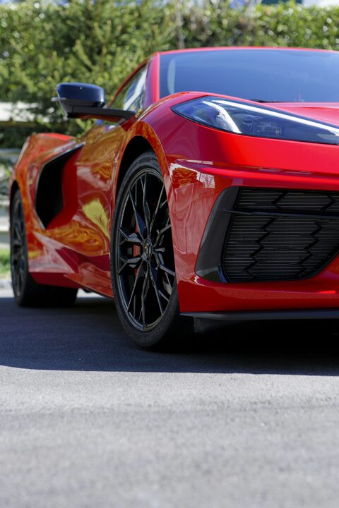 The front corner of a red Corvette