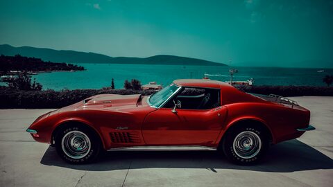 A red classic Corvette Stingray by the water