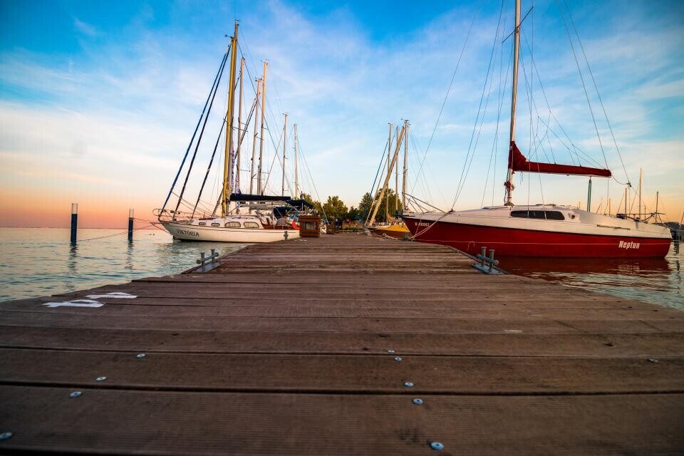 Sailboats along a wooden dock