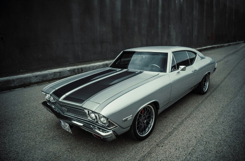 A silver classic Chevrolet Chevelle with black stripes