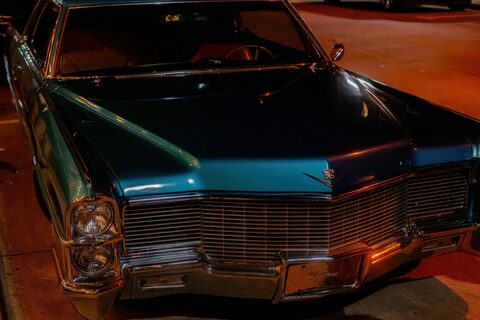 A teal classic Cadillac in warm evening light