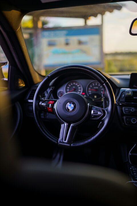 The steering wheel and gauges of a BMW