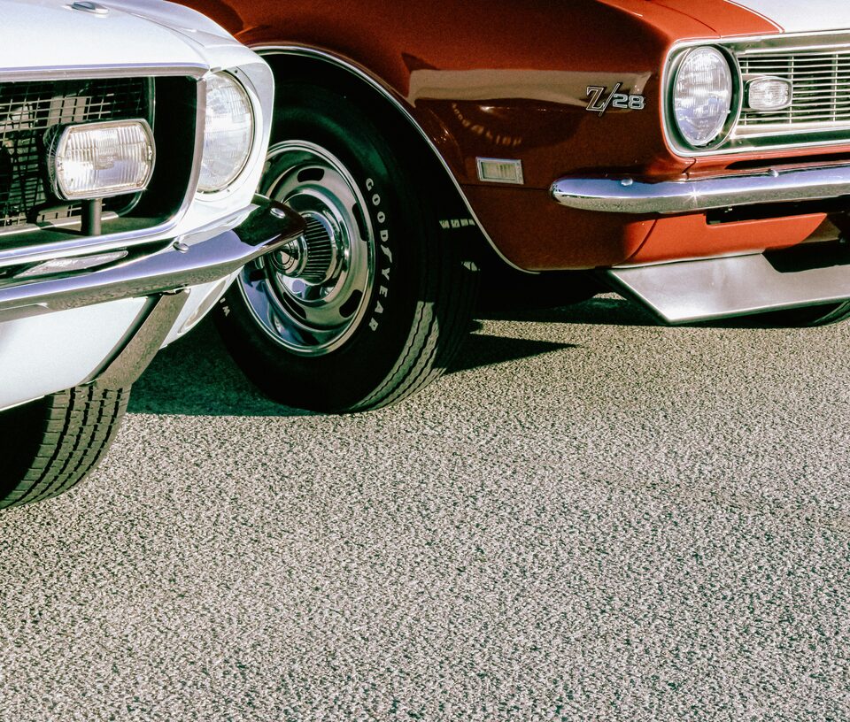 The front wheel of a red classic car