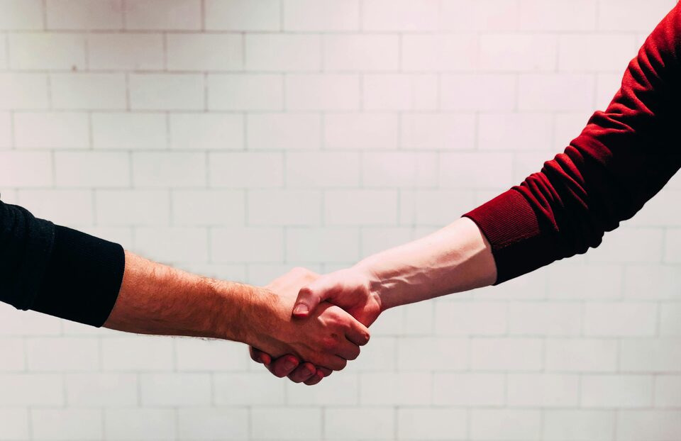 Two people shaking hands on a deal