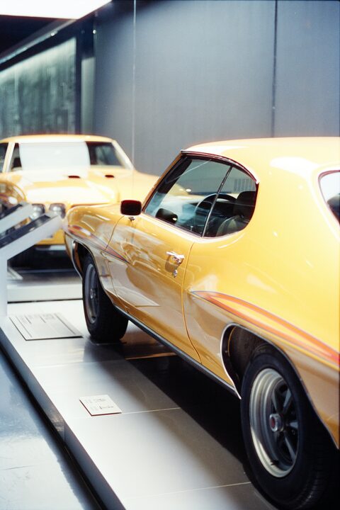 A yellow classic muscle car up close
