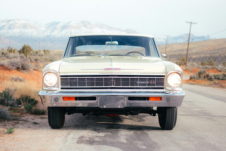 The front of a cream classic Chevrolet in the desert