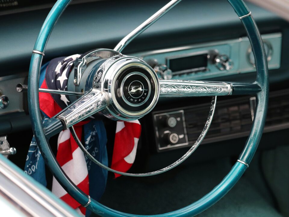 A classic steering wheel with an American flag in the seat